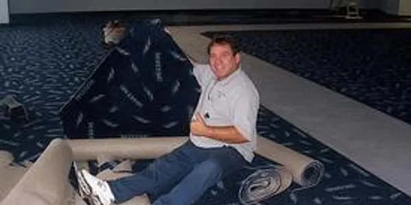 A man sitting on the floor of an airplane.